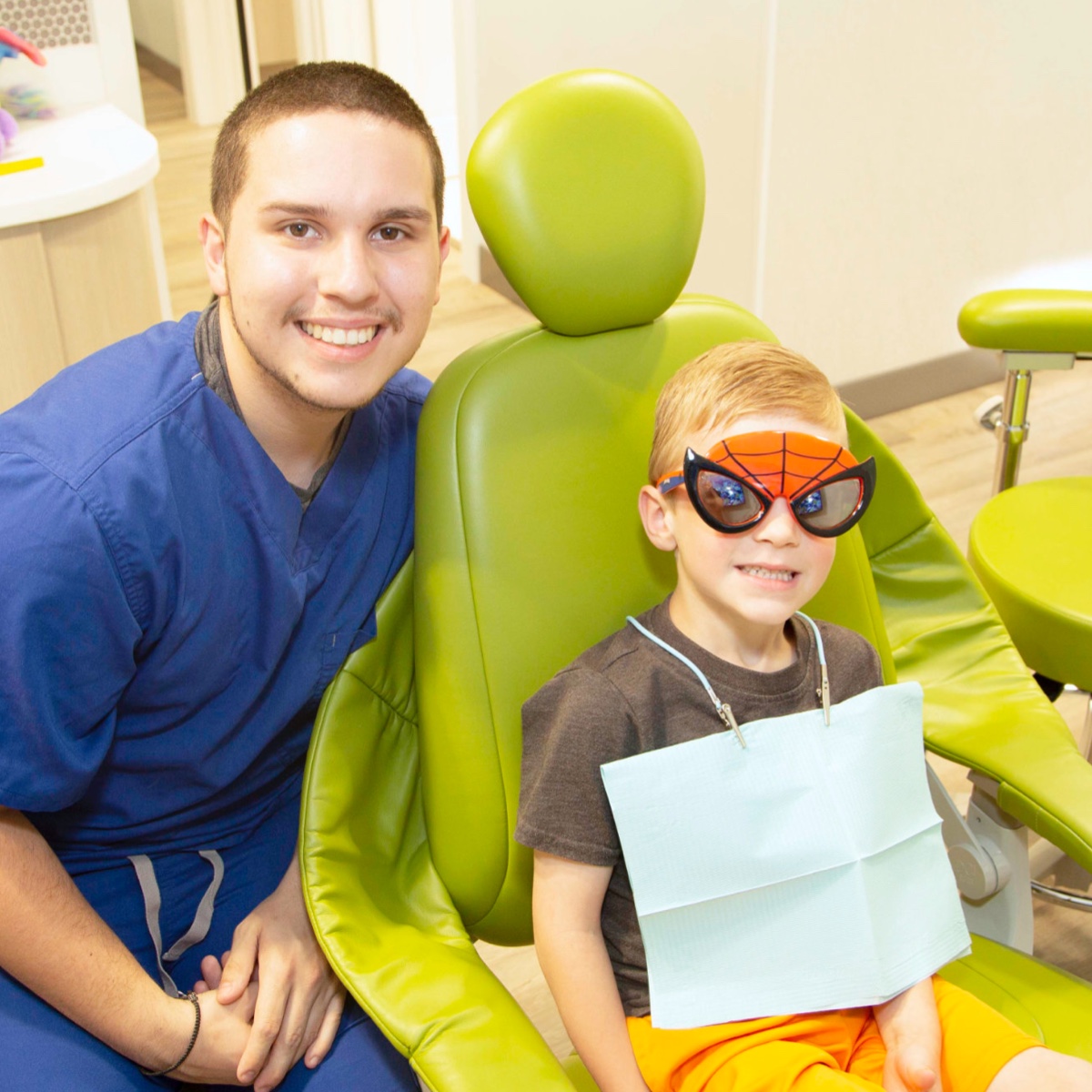 child patient smiling with doctor during visit