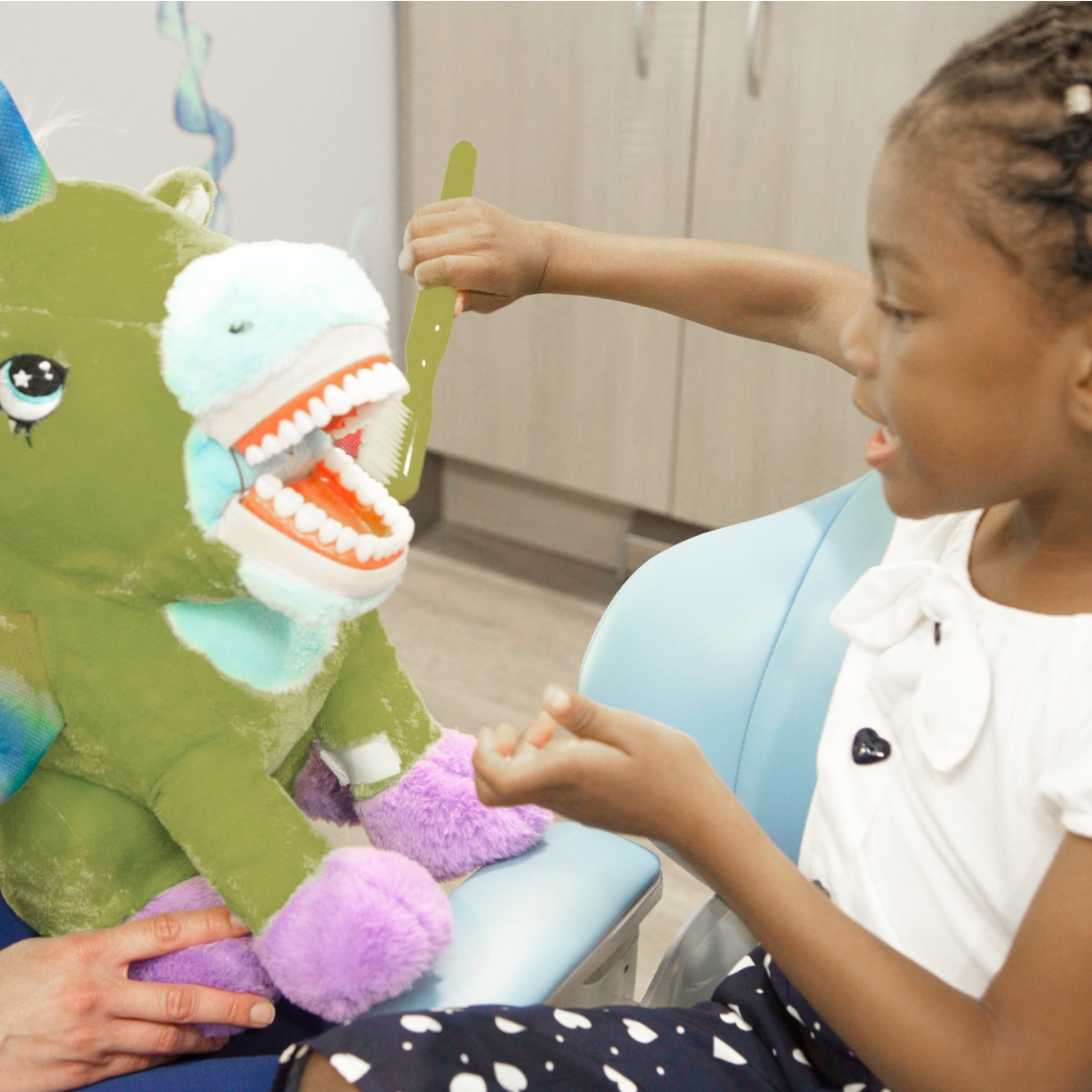 child patient sitting with stuffed animal